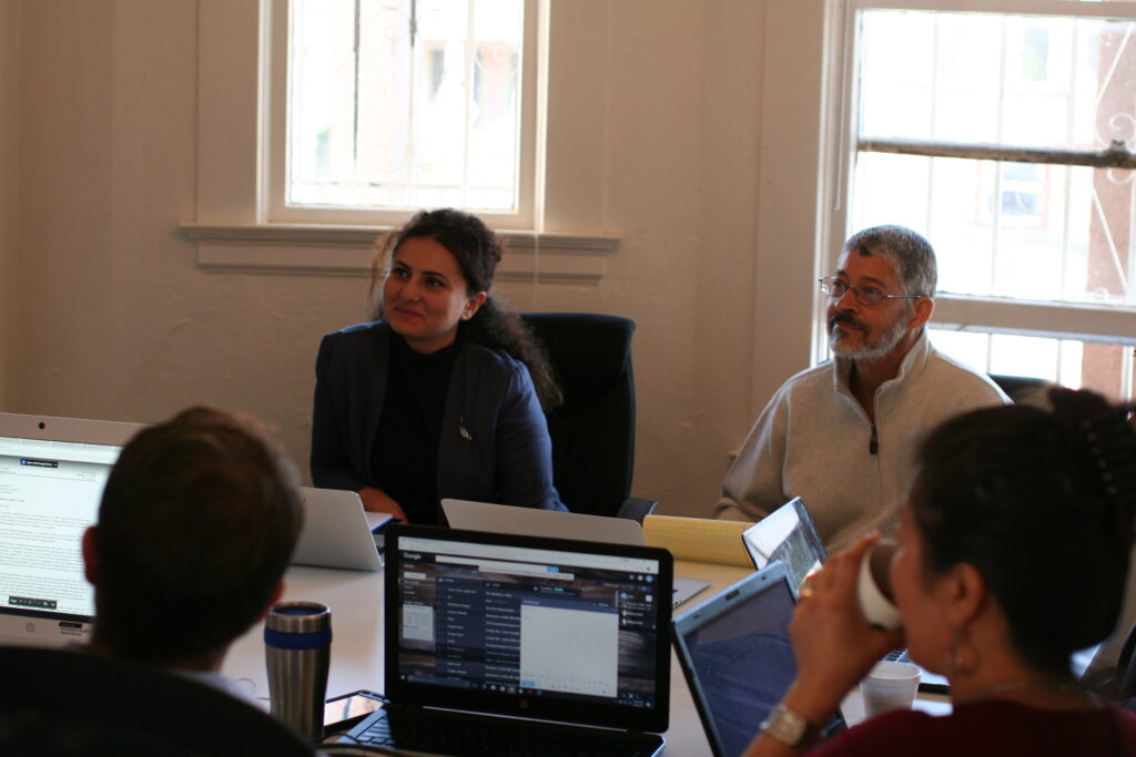 A group of employees sitting in a meeting