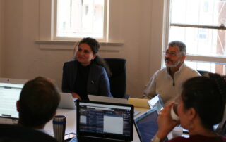 A group of employees sitting in a meeting